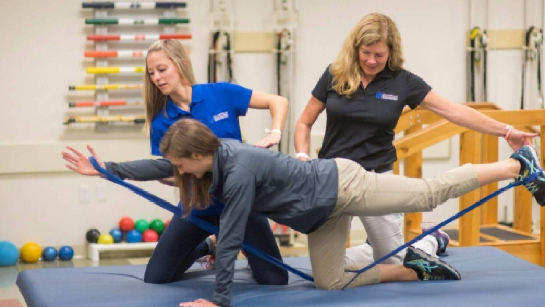 Physical therapists working with a patient